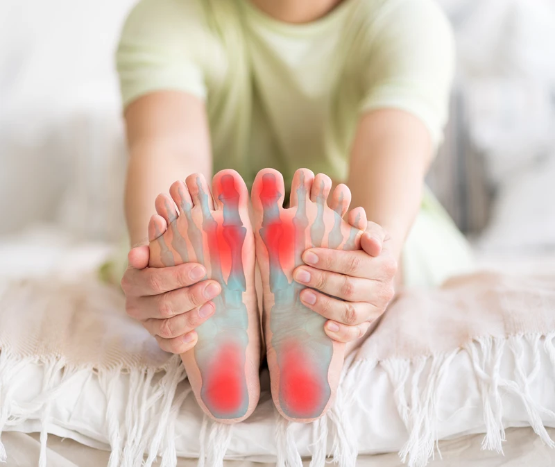 Neuropathy Baltimore MD Foot Pain Person holding their feet in pain.