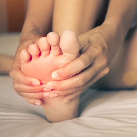 Person holding their foot.