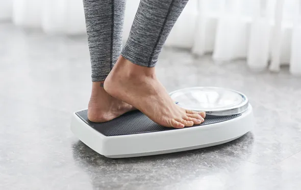 Person standing on a scale.